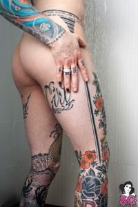 Tattooed chick Casper under the shower