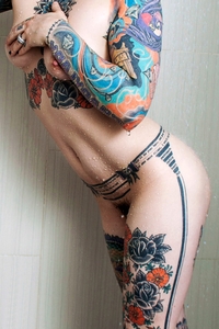 Tattooed chick Casper under the shower