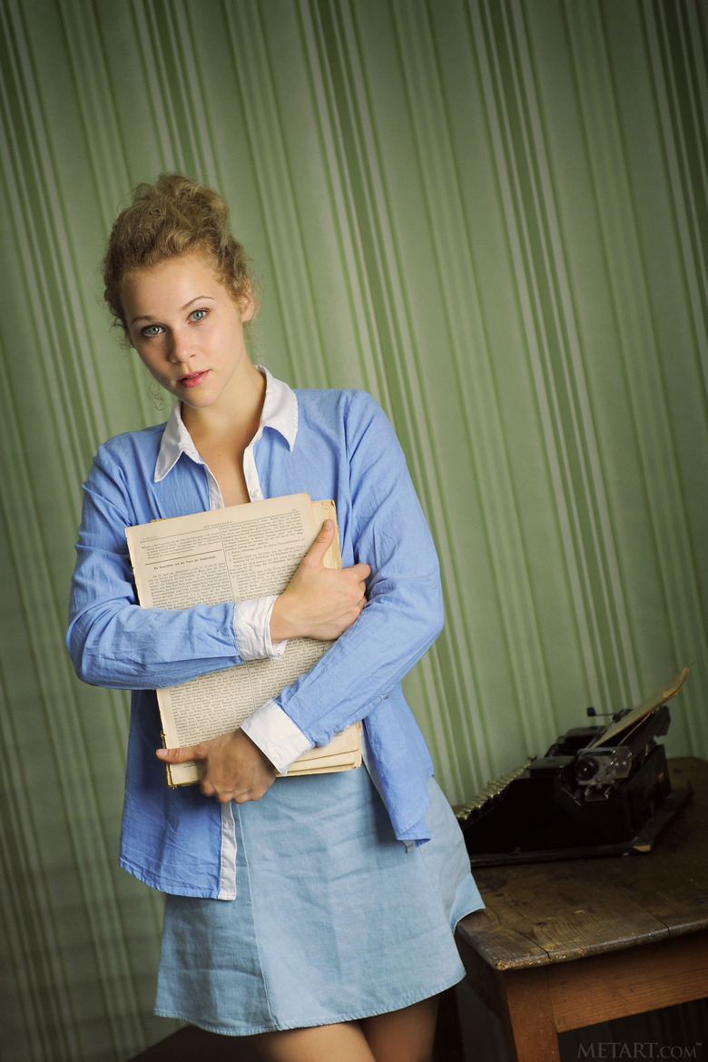 Cute blonde Helena is all business as she sits at her typewriter